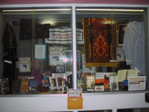 Photograph of the main campus library display window showing materials from the Muslim Journeys 