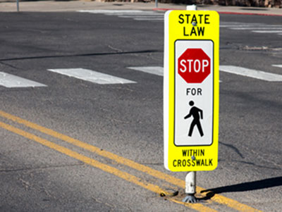crosswalk with signage State Law Stop for pedestrian within crosswalk