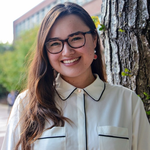 headshot of Madeline on NC State's campus, standing in front of a tree