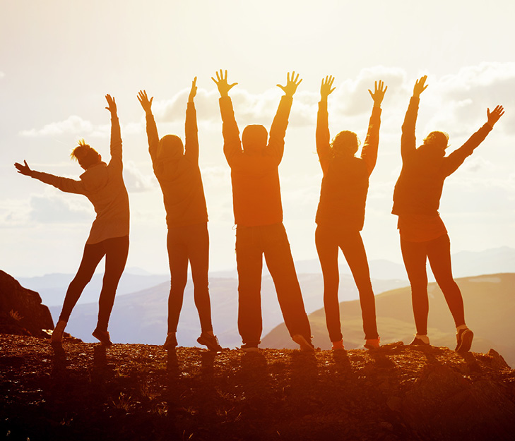 silouette of 5 students jumping for joy