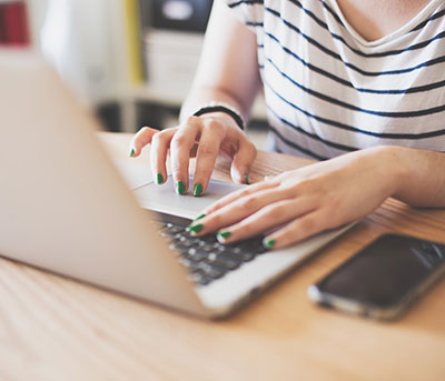 female typing on a laptop