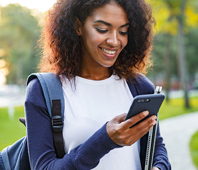 female student looking at her cell phone