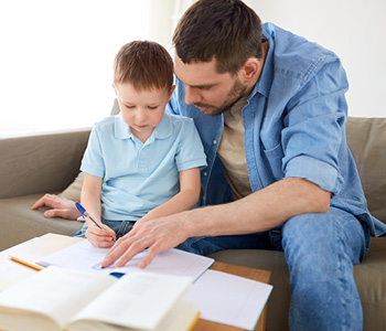 father helping his young son with homework
