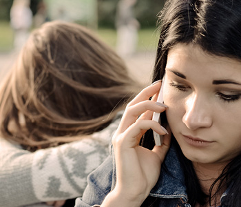 Distraught student talking on a cell phone