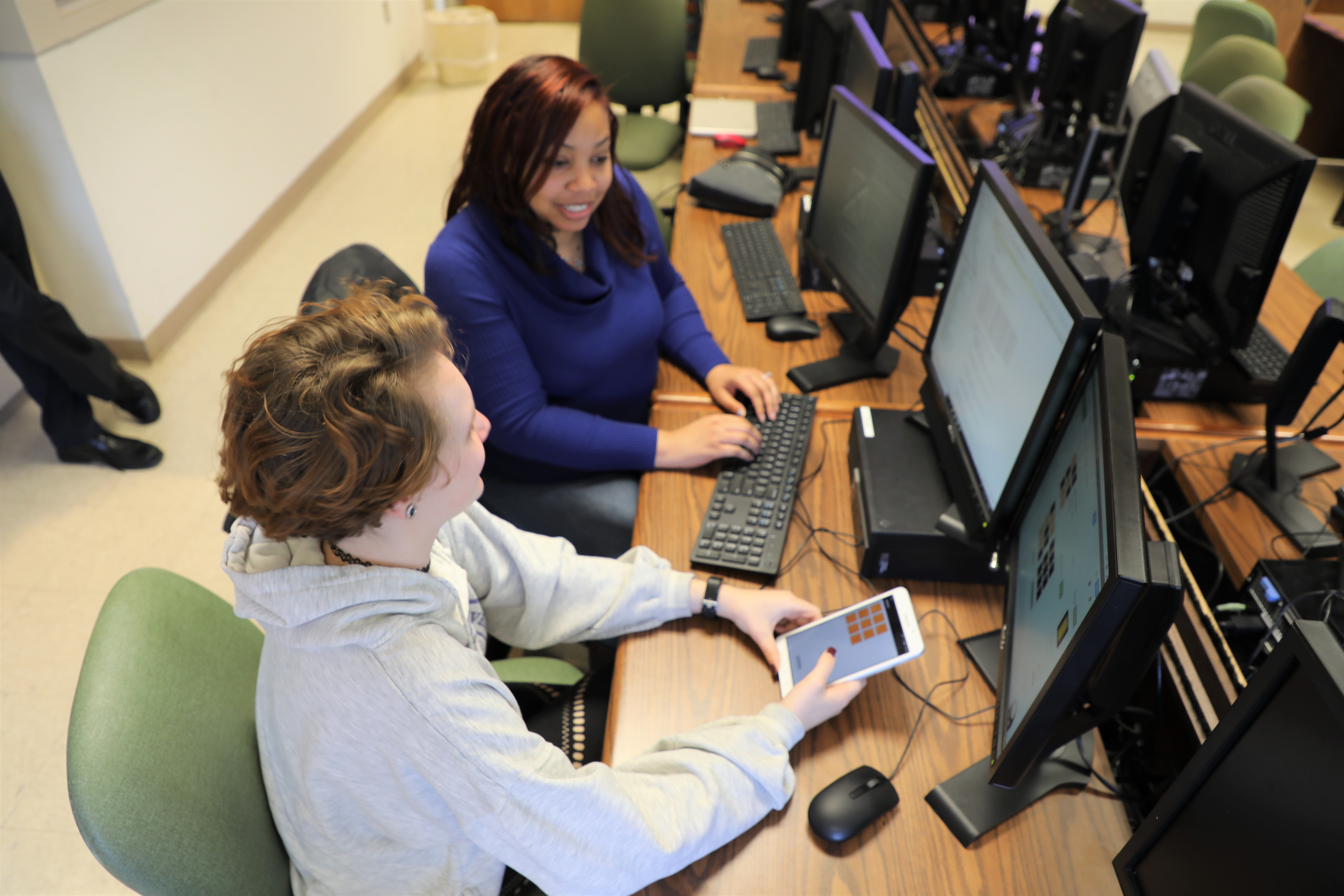 two students with tablet and computers 