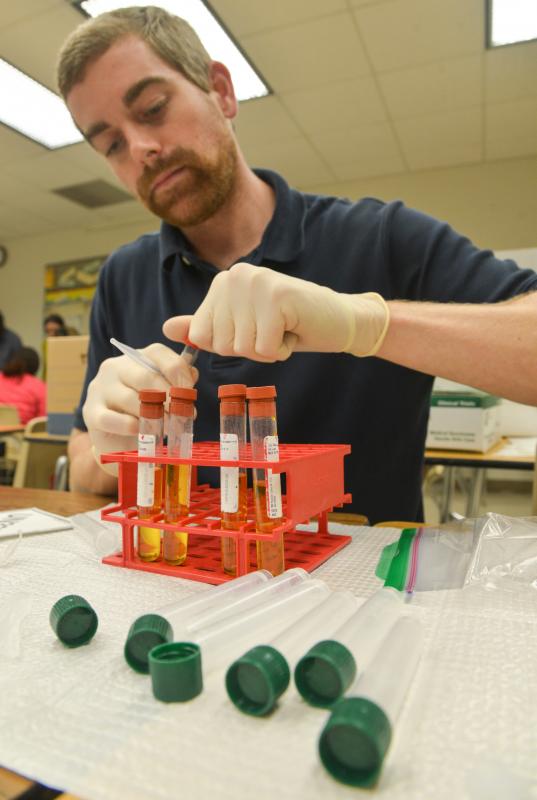 male student inserting test tube