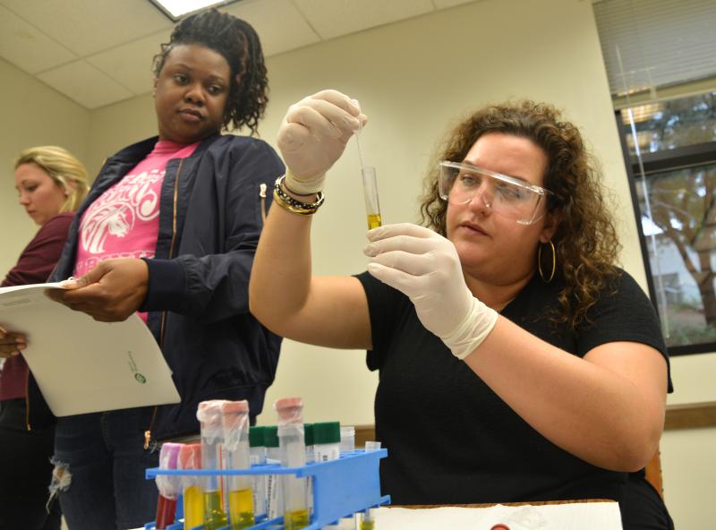 two female students with test tube