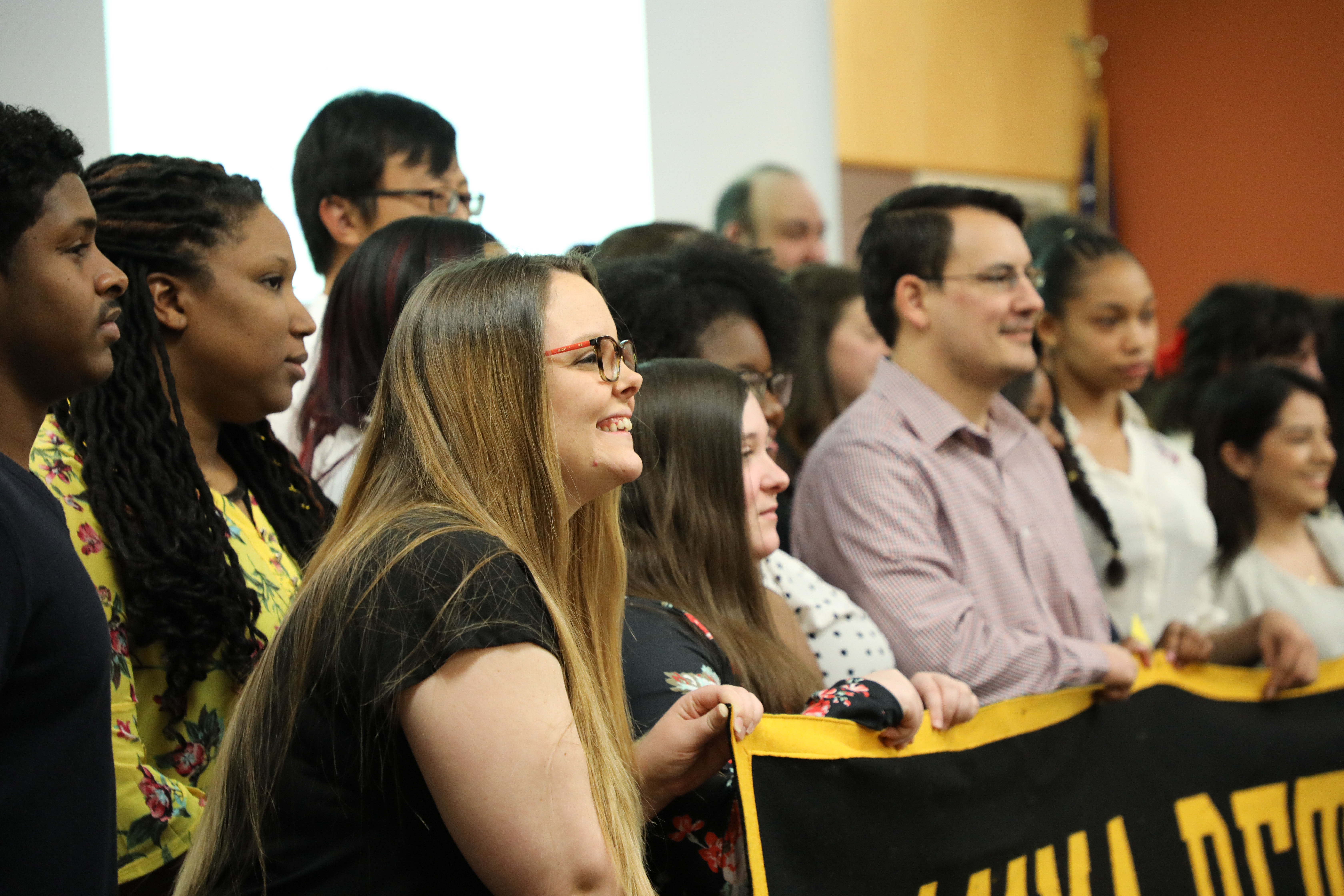 group photo of students with gamma beta sign