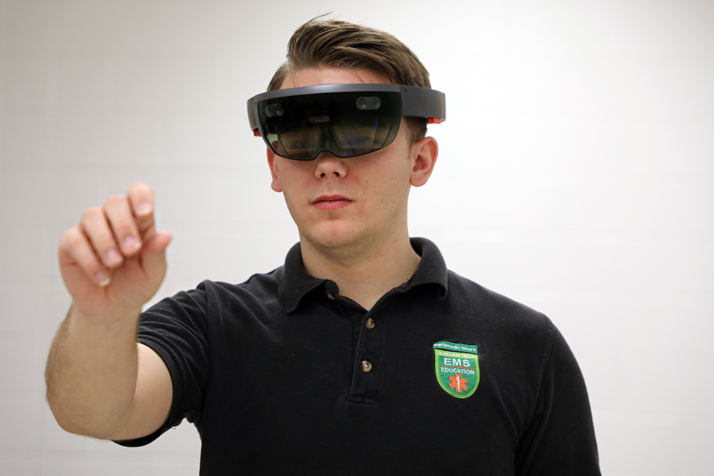 white male student uses VR glasses 
