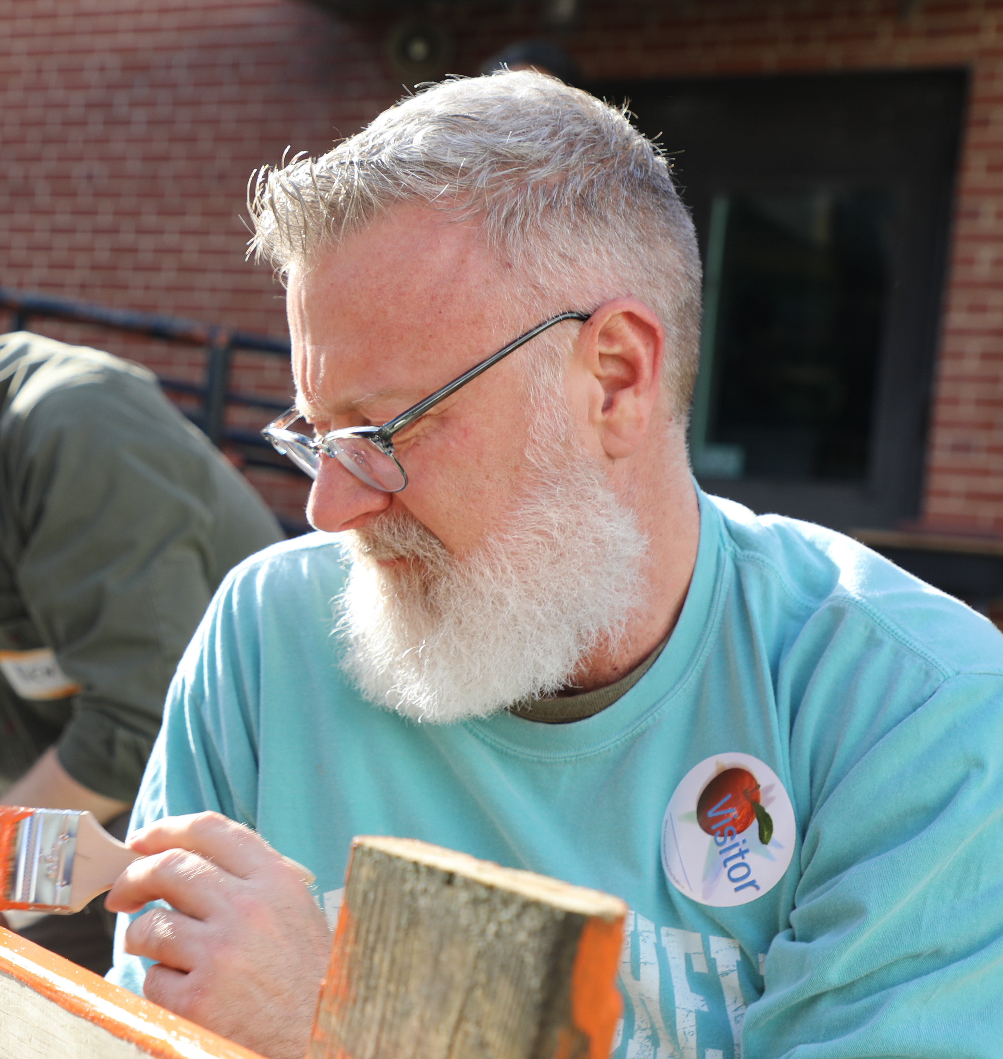 man painting bench