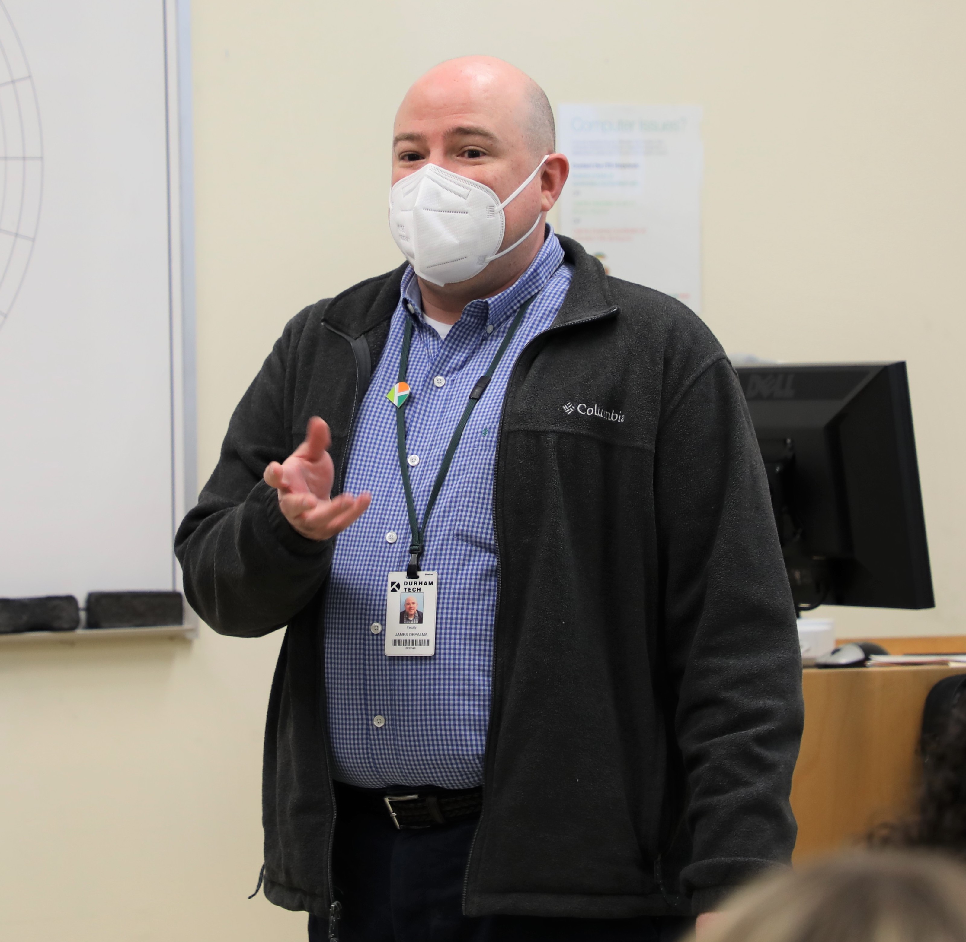 person standing with mask on teaching