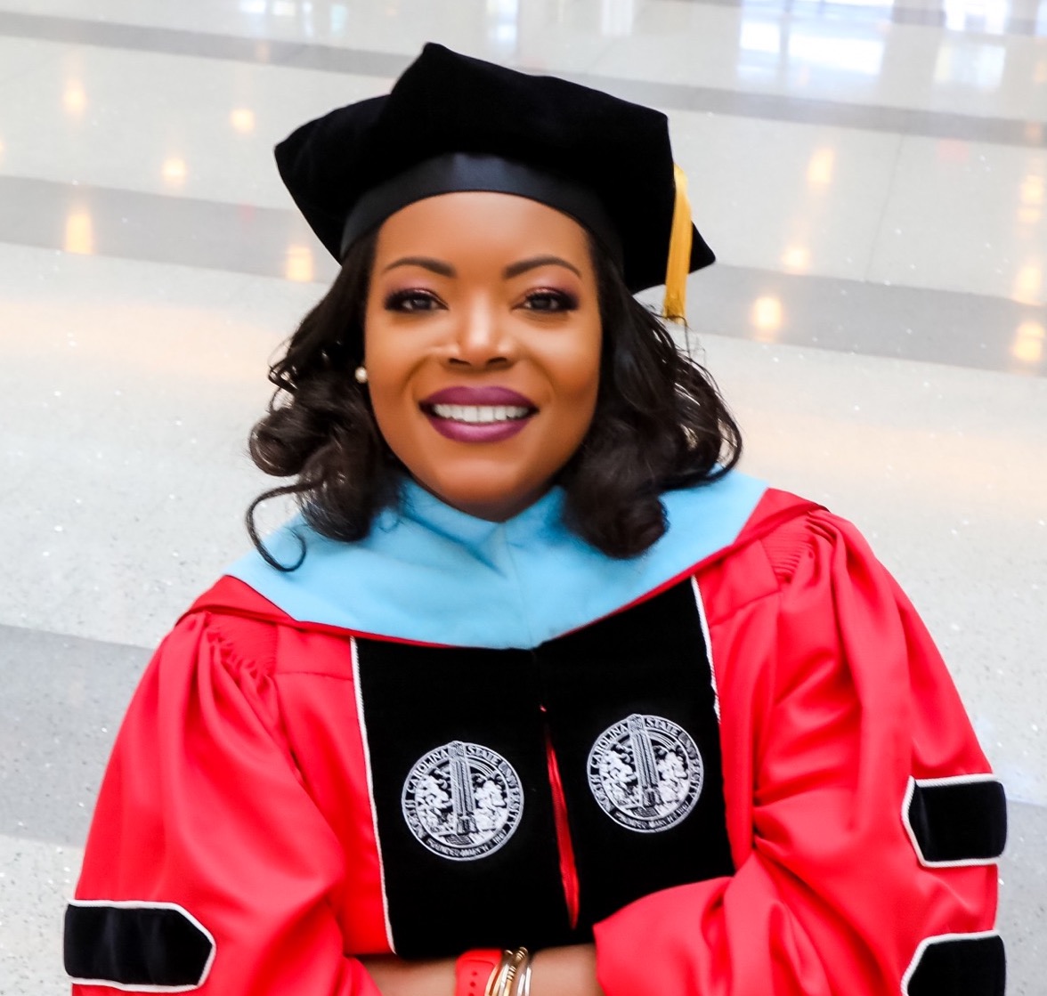 person smiling in regalia