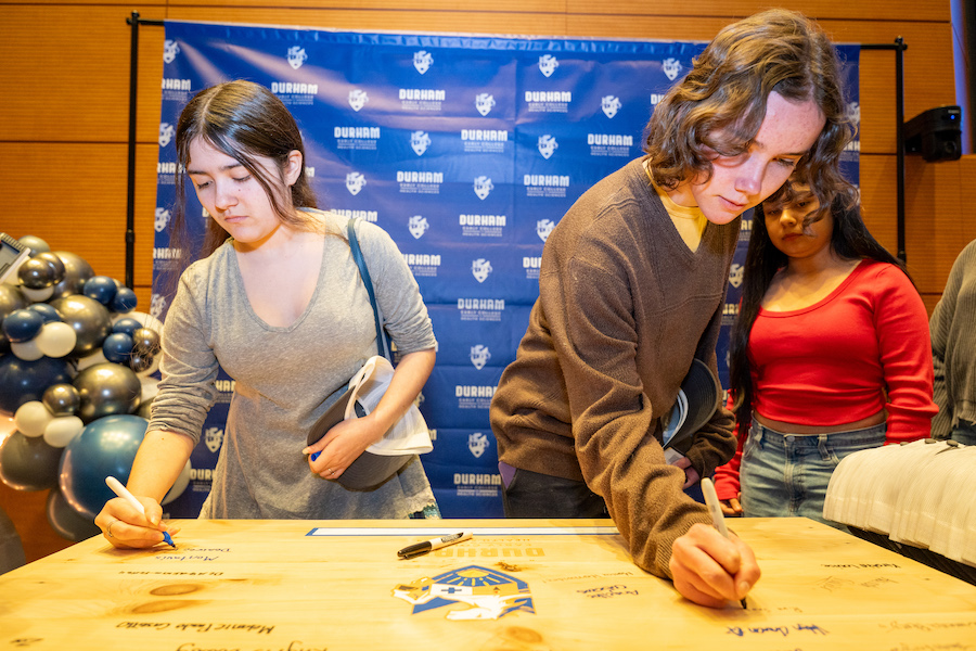 Students sign their commitment to attend the Durham Early College of Health Sciences.