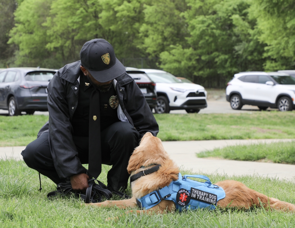 Chief Jamal Walker petting Zoe the therapy dog.
