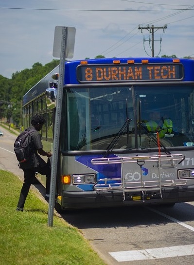 student walking onto a bus