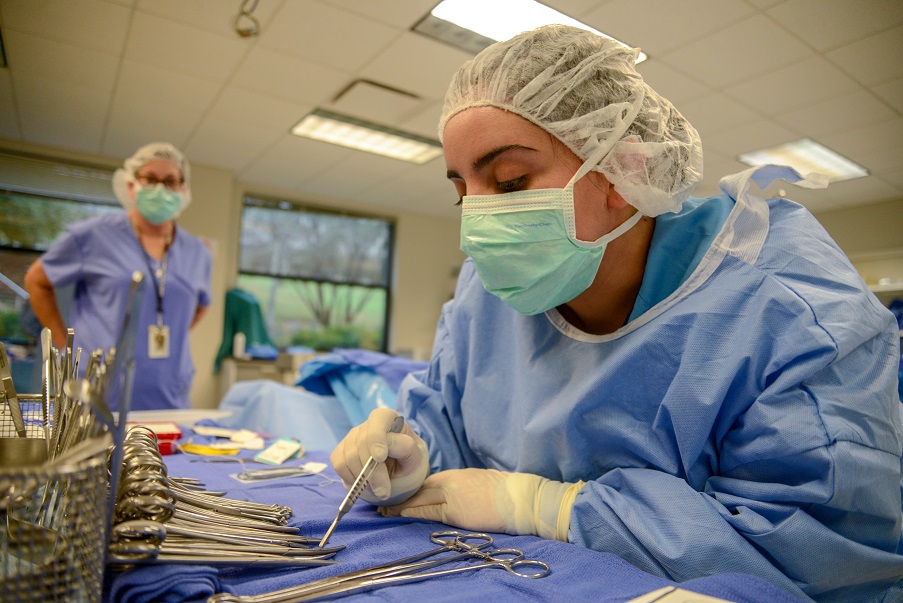 student with surgical mask counting surgical tools