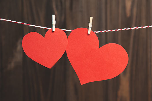 two red paper hearts clothespinned to a string