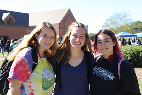 three female students smiling at the camera