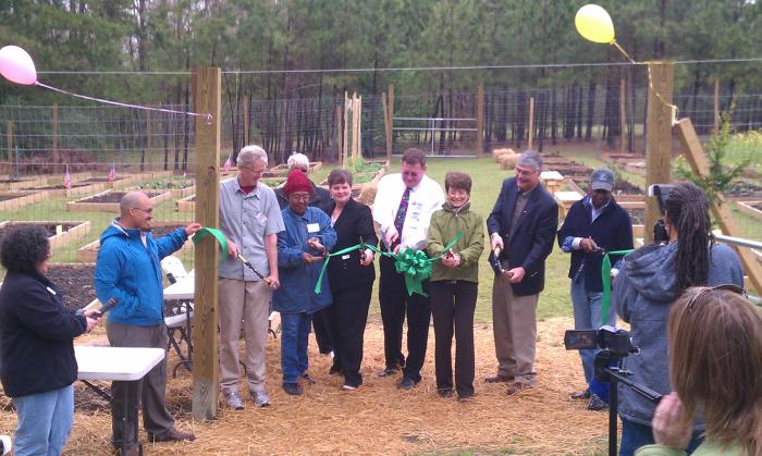 people standing in row cutting ribbon
