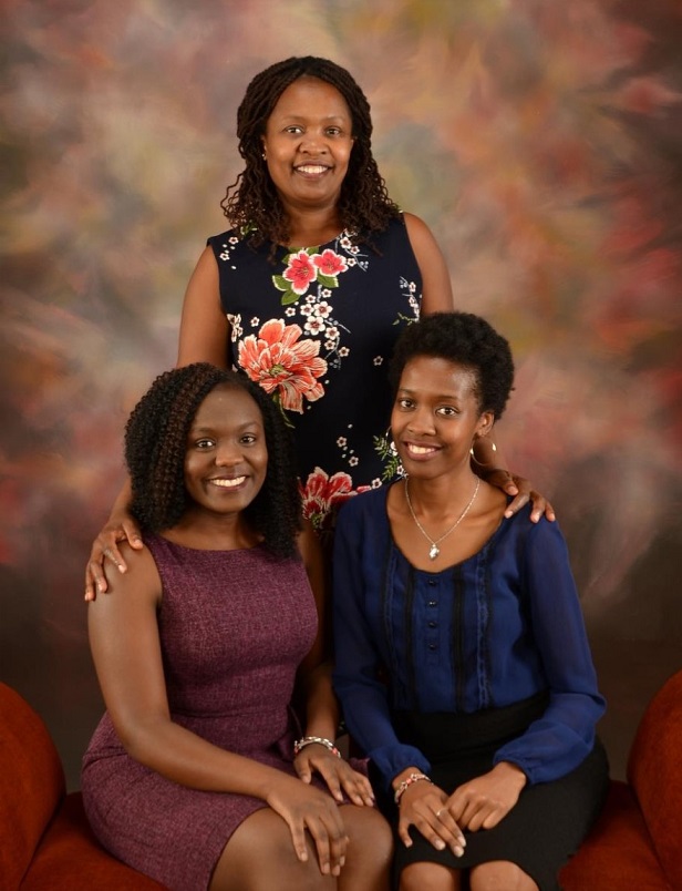 three people smiling in portrait studio