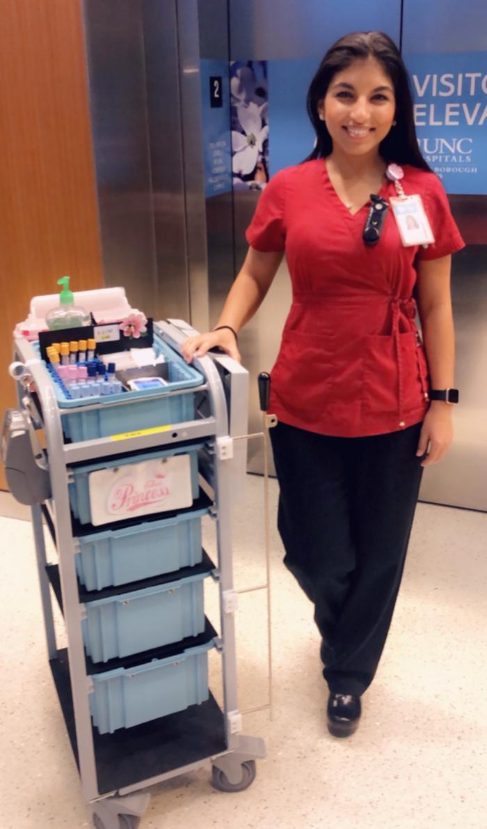 person standing next to phlebotomy cart