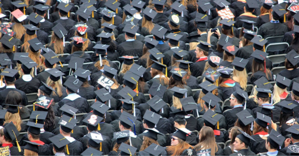group of people standing in cap and gowns