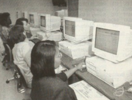 old photo of people sitting in front of computers