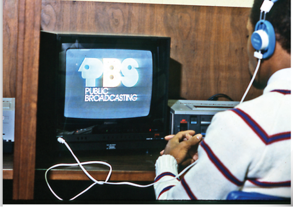 person sitting in front of old television