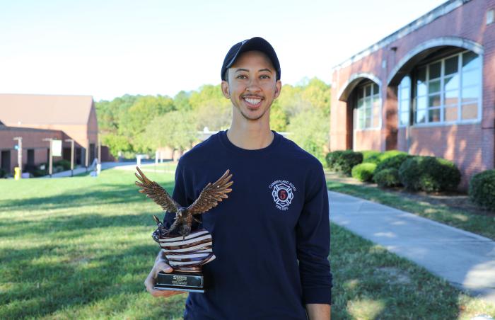 person holding eagle trophy and smiling