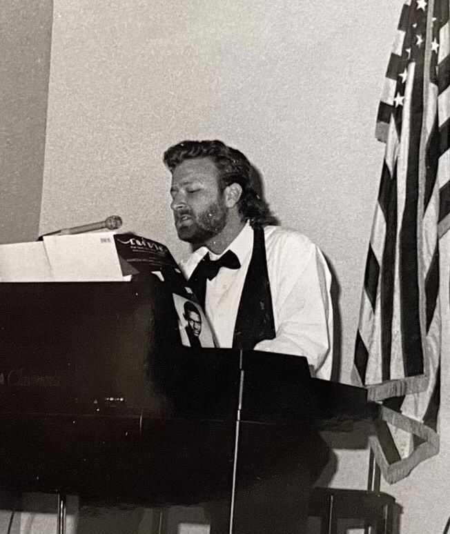 man sitting in black and white photo