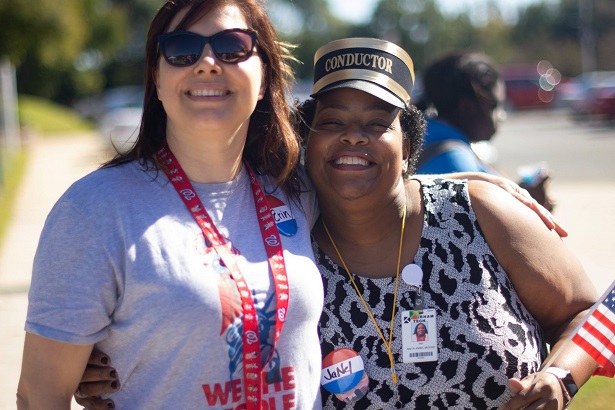 two people smiling at camera with red white and blue attire