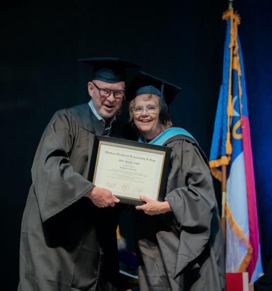 Mary Marsha Cupitt receives her honorary degree from Board of Trustees member Geoff Durham.