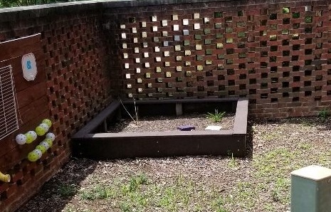 before photo of play area with garden bed