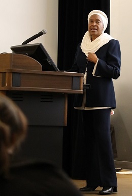 aisha speaking in front of podium