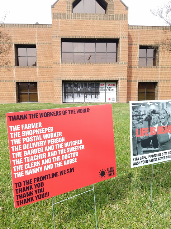 yard signs in front of building 5 on main campus