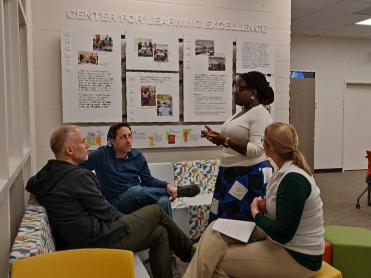 students speaking with company representatives at a career fair