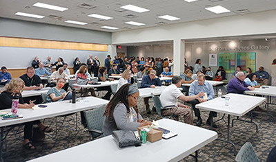 large room with instructors taking part in professional training
