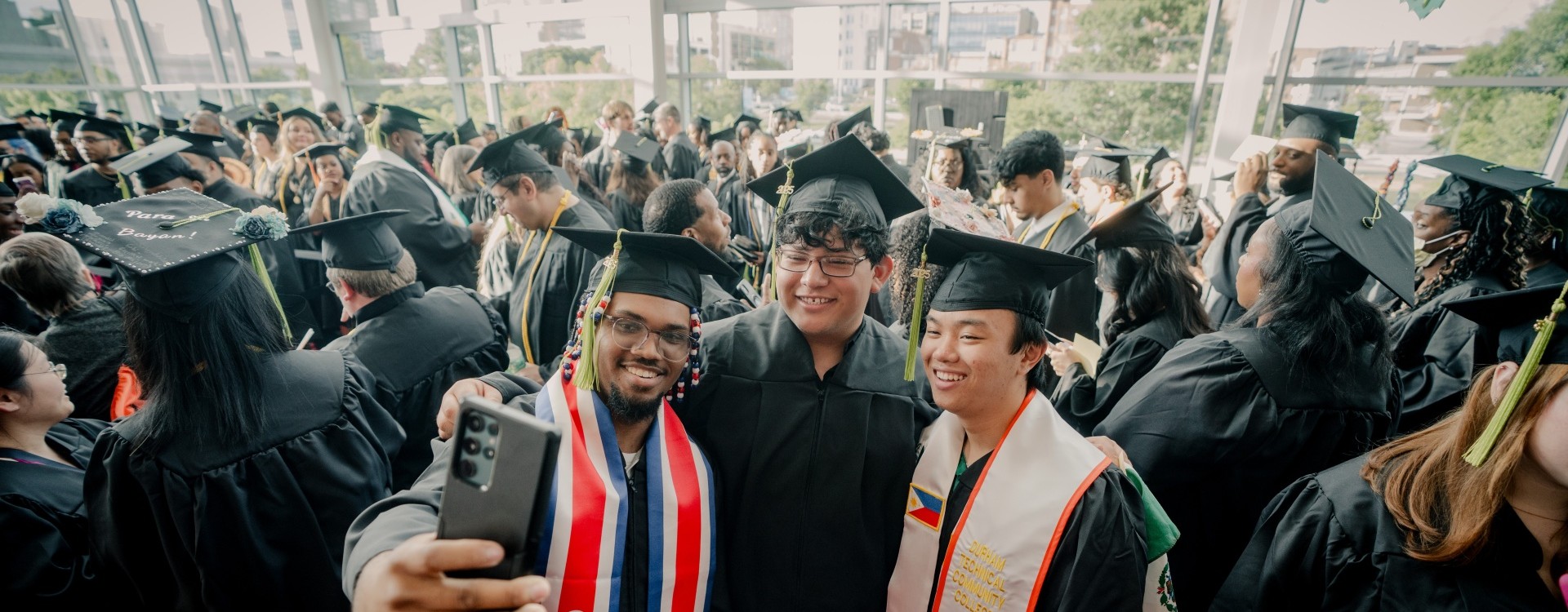 graduates taking a selfie together before the start of commencement