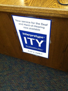 photo of a sign at the library front desk advertising the new Interpretype services