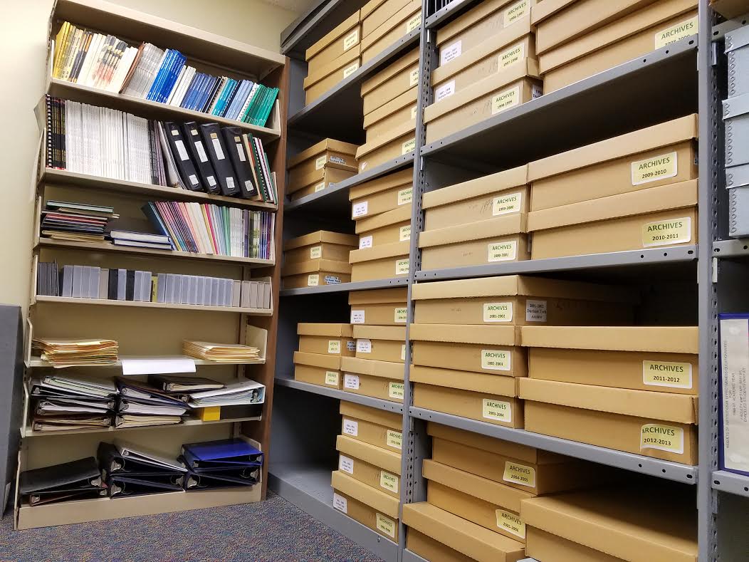 The Main Campus Library Archives Room--boxes and notebooks on shelves