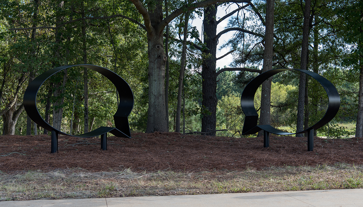 ernest and ruth by hank willis thomas, an outdoor sculpture consisting of two speech bubbles in black metal