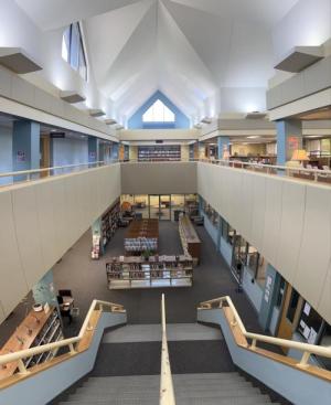 A view from the top of the Main Campus Library staircase, looking down to the newly rearranged lower-level study and browsing areas