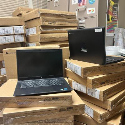 Photo of two HP Fortis Chromebooks on top of cardboard boxes