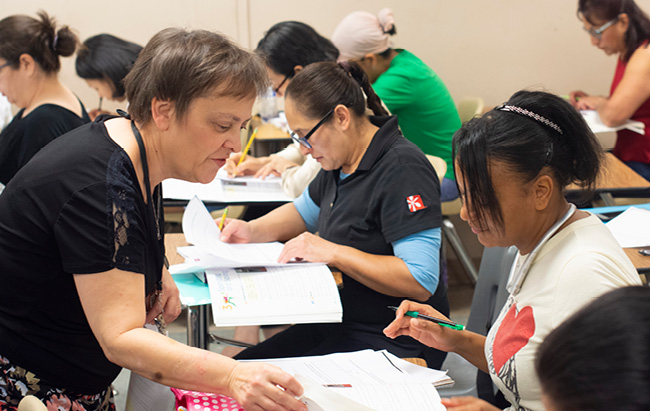 ESL instructor assists student with an English language assignment