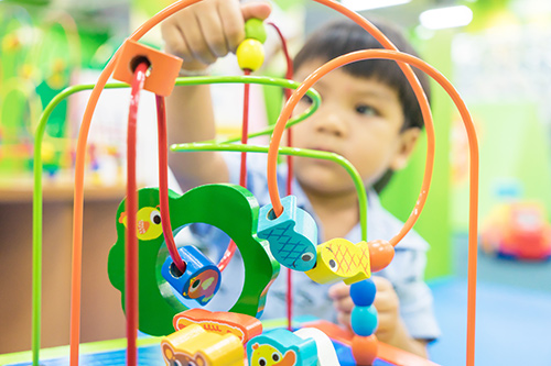 Toddler playing with a colorful toy