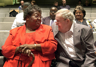 C. P. Ellis  and Ann Atwater sitting next to each other in an auditorium