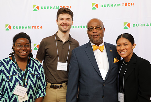 student scholarship recipients pose with a board member