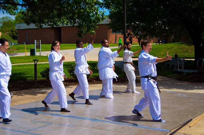 employees leads participants wearing white robe and pants in Akido on Main Campus