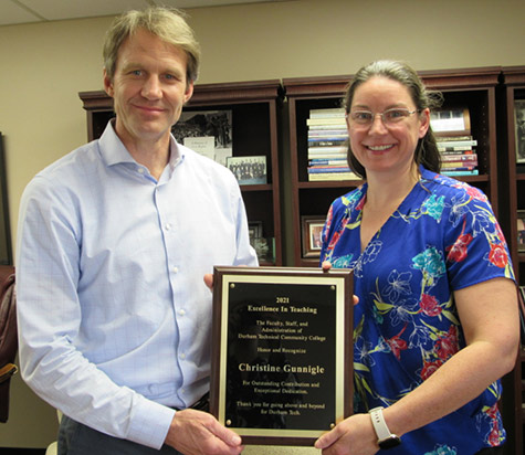 President Buxton and Christine Gunnigle hold the Excellence in Teaching Award Plaque