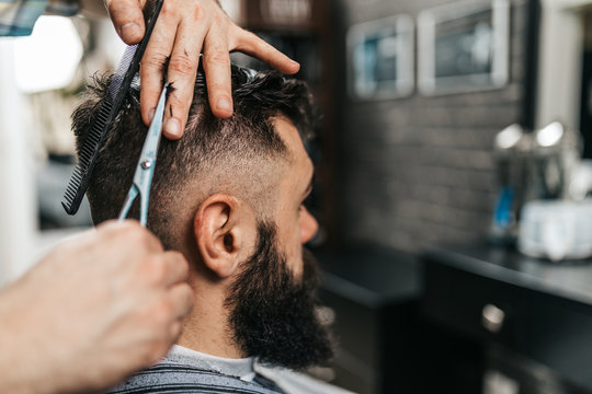 Barber cutting a client's hair in a barber shop